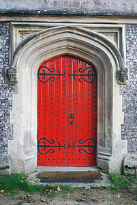 closed red wooden gate of bricked house during daytime thumbnail