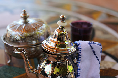 silver tea pot with white and blue pot holder thumbnail
