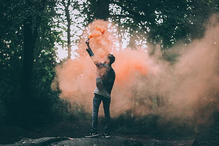 Man Throwing Peach-colored Powder thumbnail