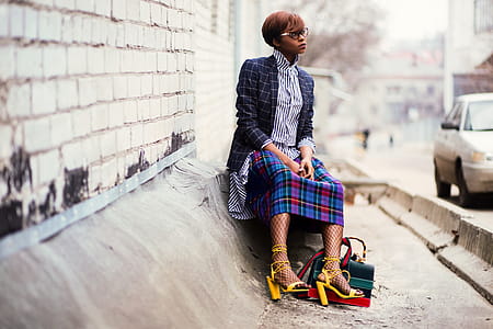 Woman Sitting of Concrete Stair Near Gray Car thumbnail