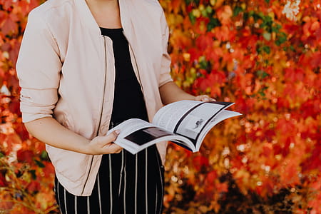 Girl with the Grafconf book on the background of colourful leaves thumbnail