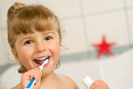 toddler girl brushing her teeth and holding toothpaste soft-tub thumbnail
