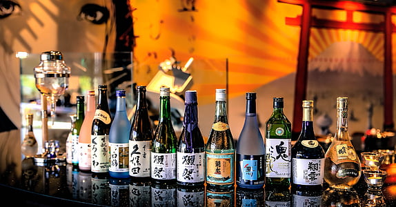 wine and vodka bottle lot on black table thumbnail