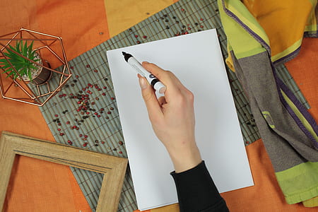 person holding black pen thumbnail