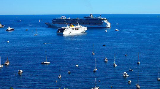 two white cruise ships sailing during daytime thumbnail