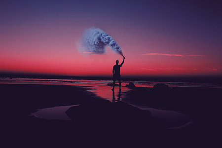 silhouette photography of person holding smoking device thumbnail