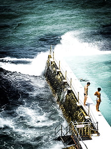 aerial photo of man and woman standing on dock thumbnail