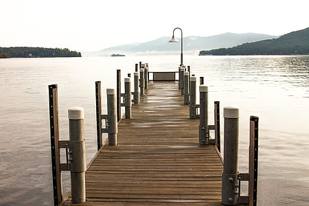 landscape photography of brown wooden dock across body of water at daytime thumbnail