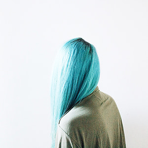 person with blue hair wearing gray top thumbnail