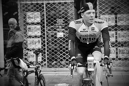 grayscale photography of man riding bicycle thumbnail