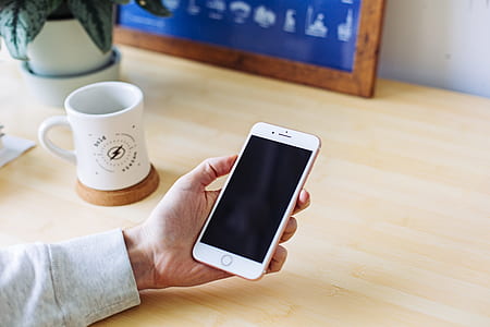 person holding gold iPhone 7 thumbnail