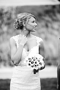 grayscale photo of woman in bridal gown holding bouquet thumbnail