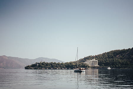 aerial photography of white building beside body of water at daytime thumbnail