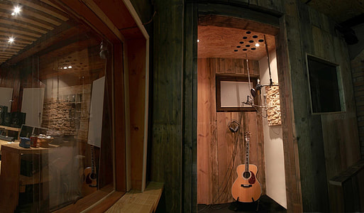 brown guitar beside wall thumbnail
