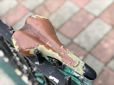 teared bike seat on fence thumbnail