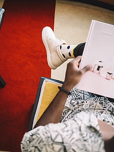 person wearing white sneaker reading book while sitting thumbnail