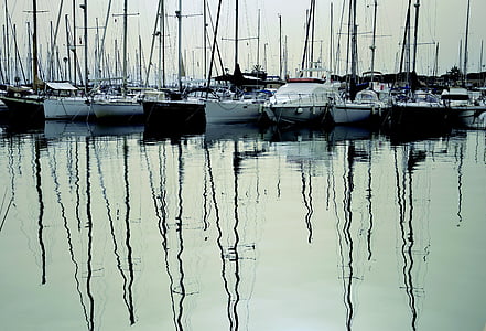 assorted boats on calm water at daytime thumbnail