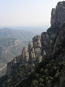 gray mountain covered with green plants thumbnail
