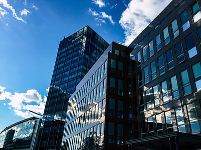 Low-angle Photography of Curtain Wall Building Taken Under White Clouds and Blue Sky thumbnail