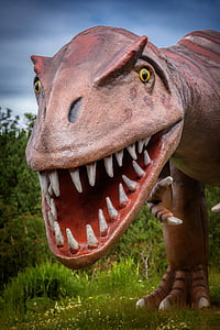 brown tyrannosaurus statue near green trees thumbnail