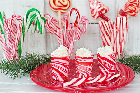 three red cups on red plate near candy canes thumbnail