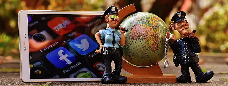 police man figurine beside smartphone thumbnail