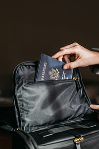 Person Putting a Passport on Bag thumbnail