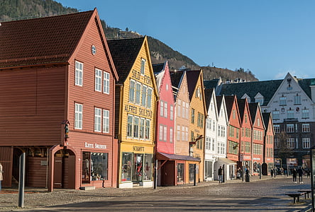 assorted-color wooden houses under bright sky thumbnail