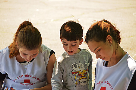 boy between two women looking down thumbnail