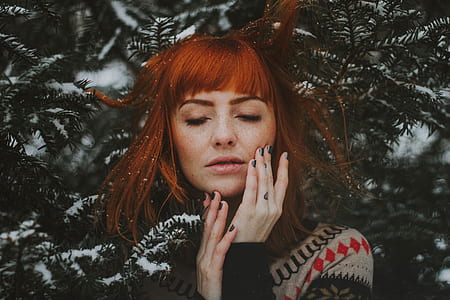 woman standing near green fir trees covered with snow thumbnail