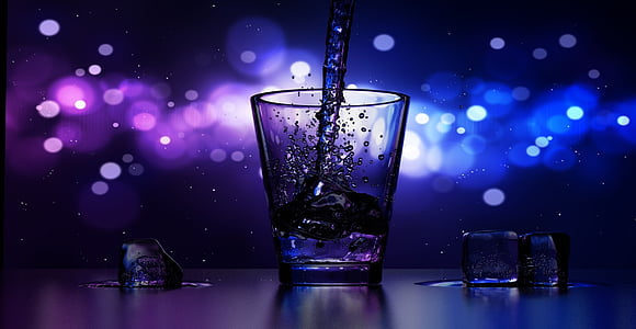 bokeh time lapse photography of liquid poured on shot glass thumbnail