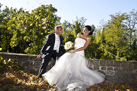 male and female sitting on concrete bench thumbnail
