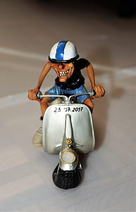man riding on gray motor scooter miniature on white surface thumbnail