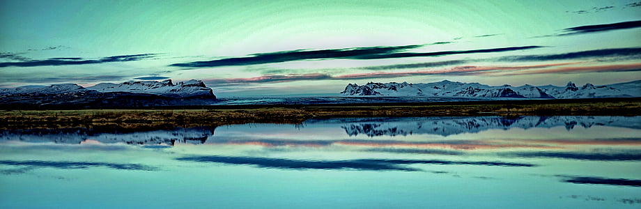 body of water near mountain covered by snow thumbnail