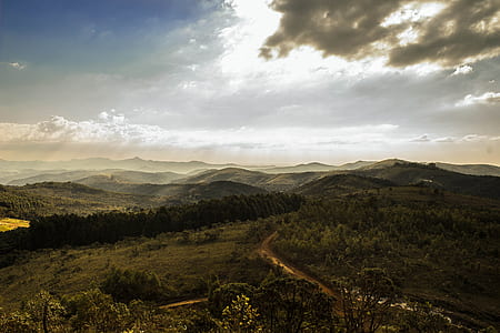 landscape photograph of mountain range under gray sky thumbnail