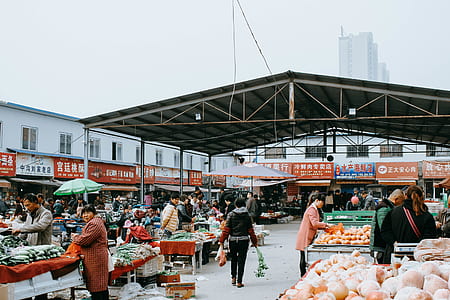 people on market under white sky thumbnail