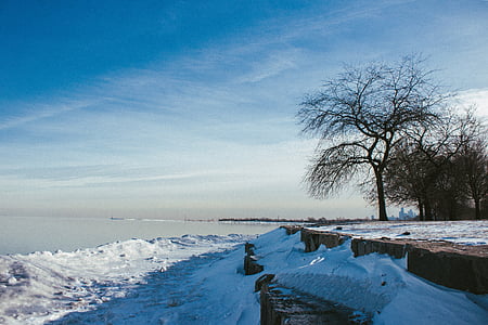 snow covered land under blue sky thumbnail
