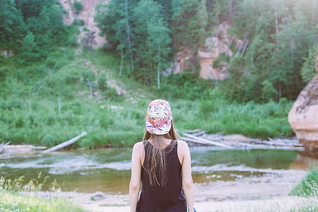 woman standing in front of body of water during daytime thumbnail