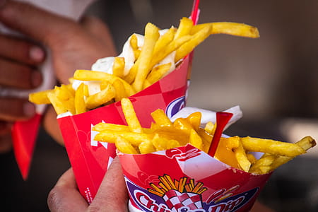 Person Holding Two Potato Fries Packs thumbnail