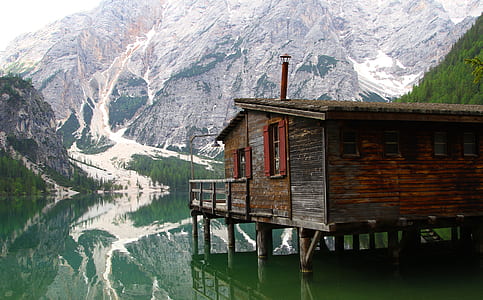 brown wooden house on lake thumbnail
