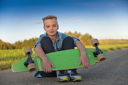 boy holding green skateboard thumbnail
