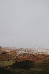 overlooking grass field and mountains thumbnail