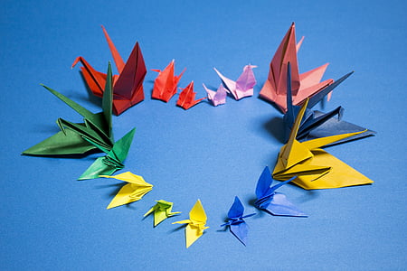 assorted-color bird origami on blue surface thumbnail