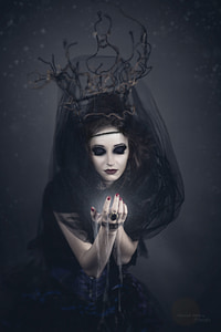 woman wearing black cap-sleeved gown and black veil thumbnail
