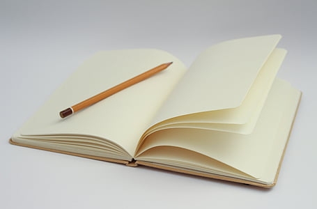white open notebook and pencil photo thumbnail