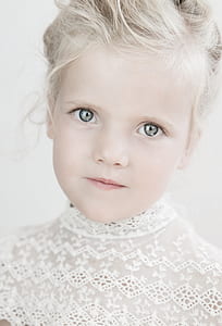 closeup photo of girl wearing white knitted crew-neck top thumbnail