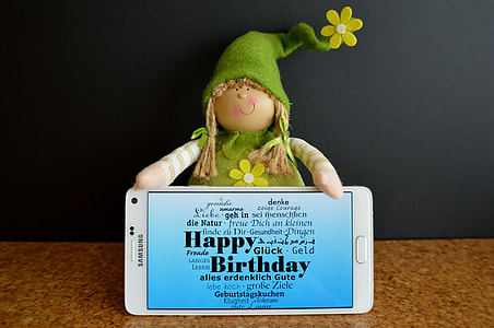 white Samsung Galaxy Note beside female plush toy thumbnail