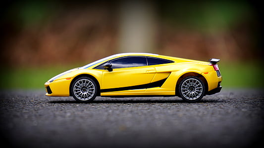 yellow Lamborghini Gallardo scale model on pavement thumbnail