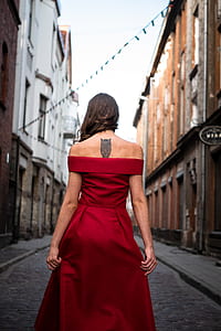 woman wearing red dress facing backwards thumbnail