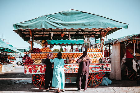 two women standing in front of food cart thumbnail
